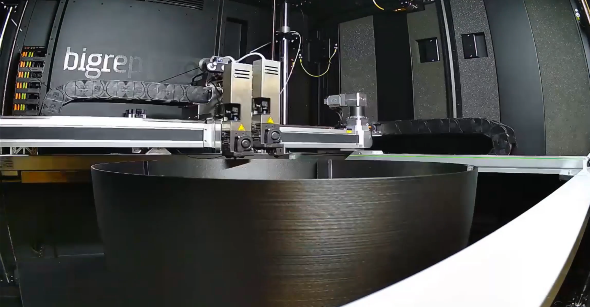 Large-format additive manufacturing in-progress part on build surface